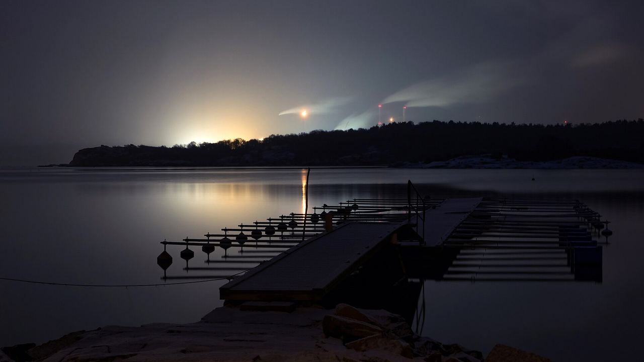 The Preemraff oil refinery at Brofjorden, Sweden, lit at night in falling snow