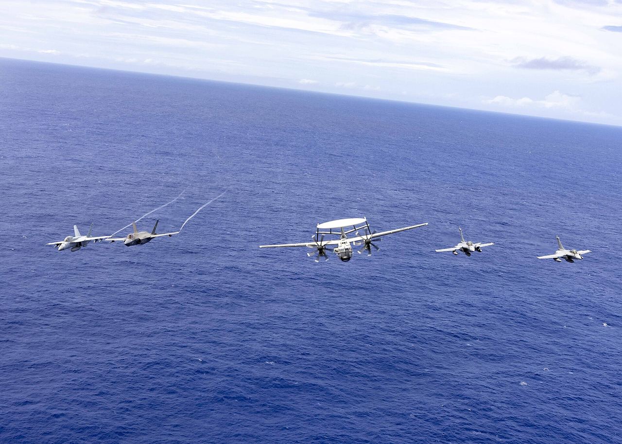 US and French carrier aircraft flying in formation over the Philippine Sea, 2025